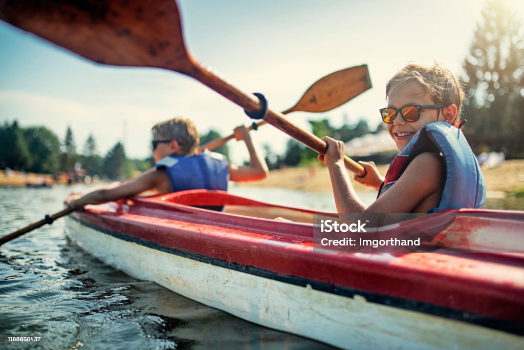 Two boys enjoying kayaking on lake Two boys enjoying kayaking on lake on sunny summer day.
Nikon D850 Family Stock Photo