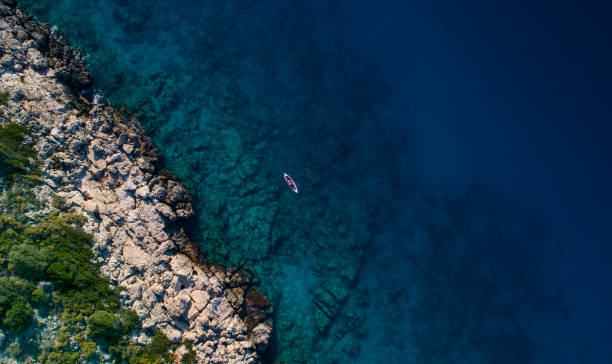 istock Woman kayaking clear turquoise sea 1188851858
