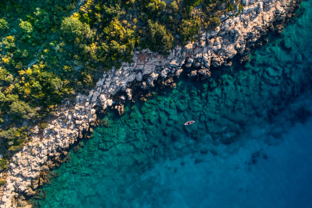 istock Woman kayaking clear turquoise sea 1188851898