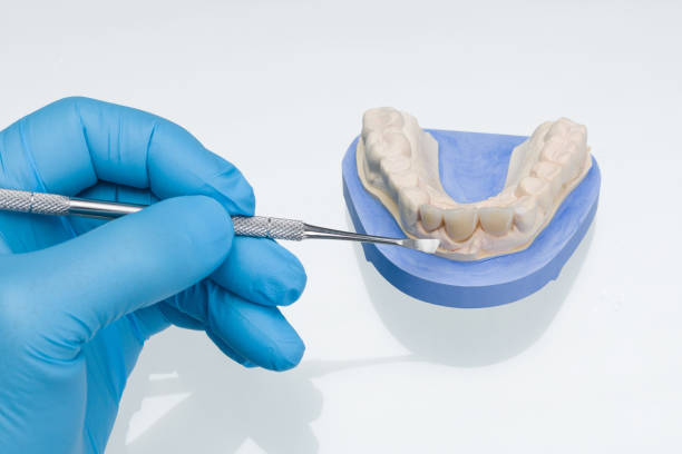 istock Close up of work on denture in dental laboratory 1188851923