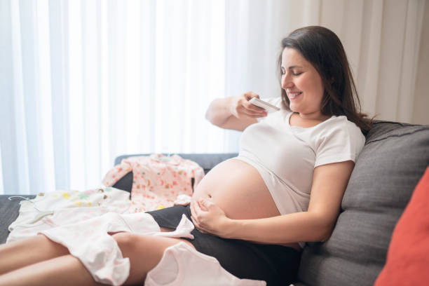 istock Baby clothes, taking photo 1188852221