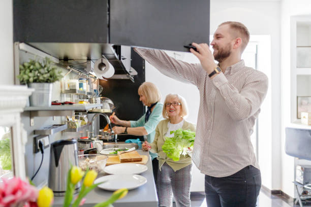 istock Young man in the kitchen helping senior women 1188852403