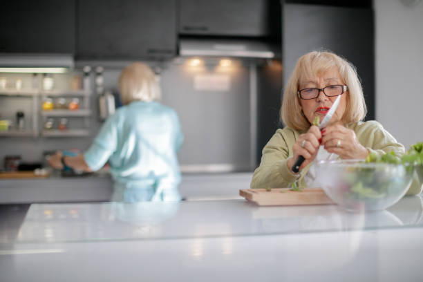 istock Senior woman preparing salad 1188852477