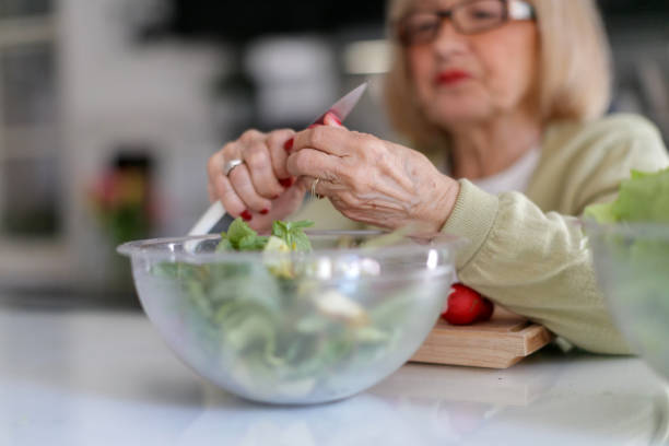istock Senior woman preparing salad 1188852486