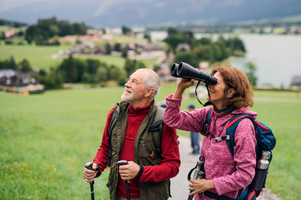 istock Senior pensioner couple hiking in nature, using binoculars. 1188854064