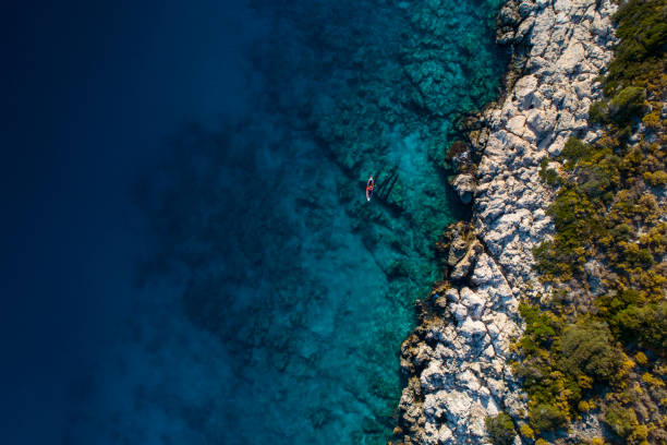 istock Woman kayaking clear turquoise sea 1188855690