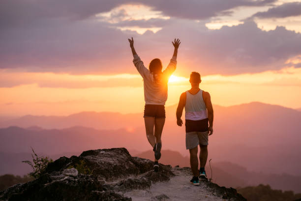 istock Happy couple walks in sunset mountains 1188856551