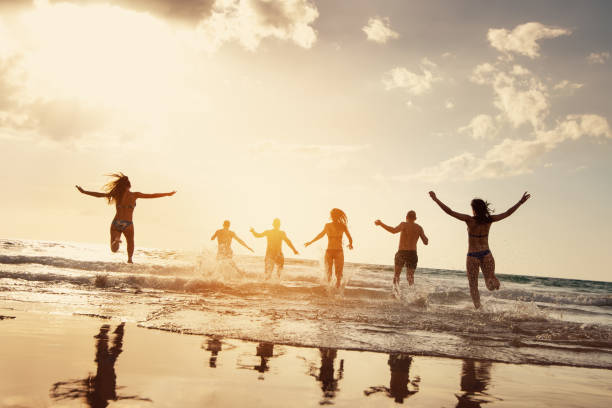 istock Friends runs at sunset sea beach 1188856801