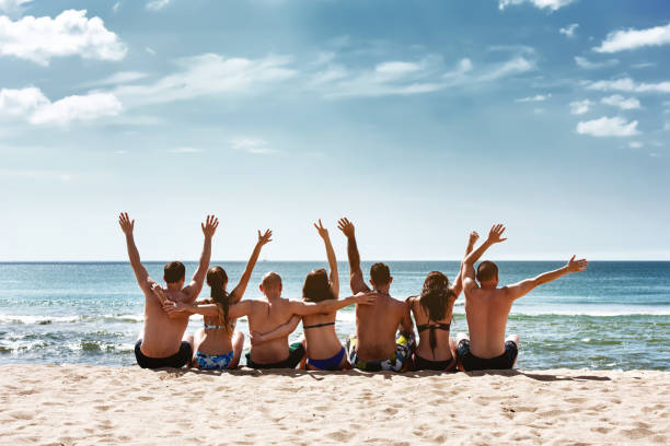 istock Group friends having fun sea beach together 1188856840