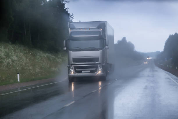 truck moving in rain and fog truck moving in rain and fog on a country road truck rain stock pictures, royalty-free photos & images