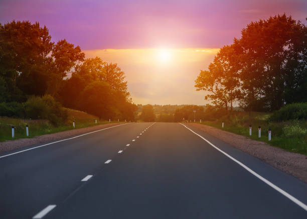 istock sunset over the country highway 1188856958