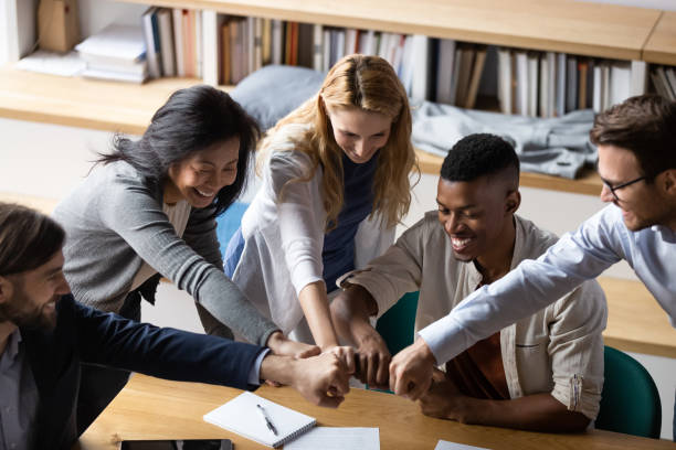istock Overjoyed group of mixed race employees bumping fists. 1188856997