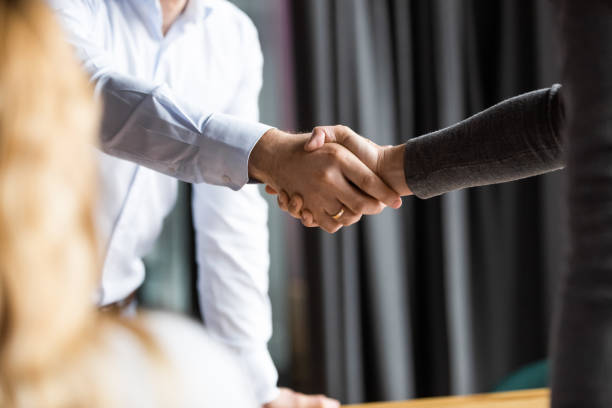 istock Close up two businessmen shaking hands in office. 1188857001