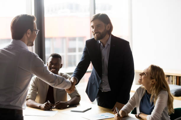 istock Happy businessmen shaking hands with client, greeting or making agreement. 1188857005