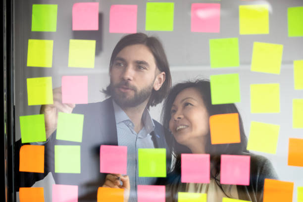 istock Manager working with middle aged korean supervisor near glass wall. 1188857009