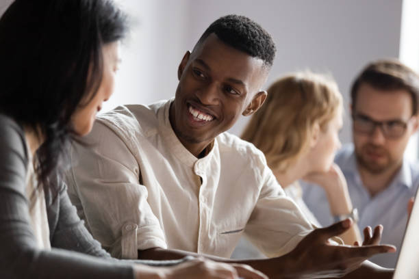 istock Happy african american young worker discussing project ideas with leader. 1188857010