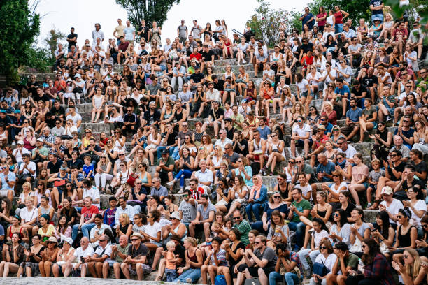 People watching performance of a street artist in the Mauerpark. Mauerpark is a public park in the Prenzlauer Berg district. Flea market in Mauerpark is frequently used as sunday afternoon activity by hip Berliners and tourists. The flea market itself consists of mainly private salespersons who offer various items.