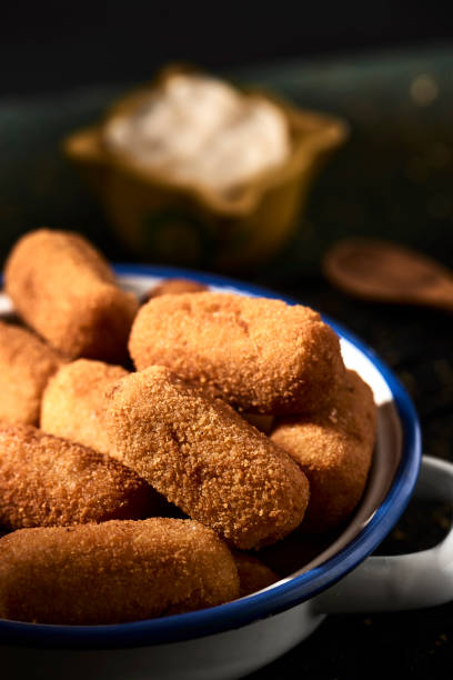 istock spanish croquettes on a rustic wooden table 1188859918