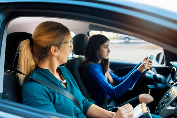 istock Teenager having driving lesson with female instructor 1188863290