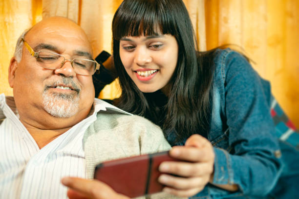 istock Happy father and daughter share a smartphone. 1188864891