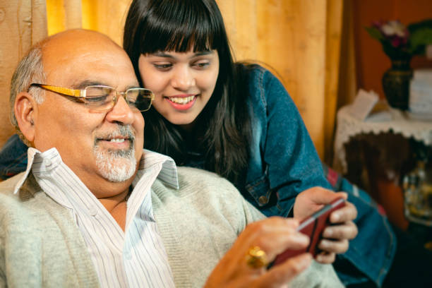 istock Happy father and daughter share a smartphone. 1188865048