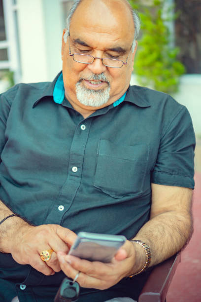 istock Bespectacled, retired senior man uses a smartphone. 1188865088