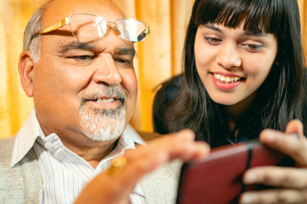istock Happy father and daughter share a smartphone. 1188865155