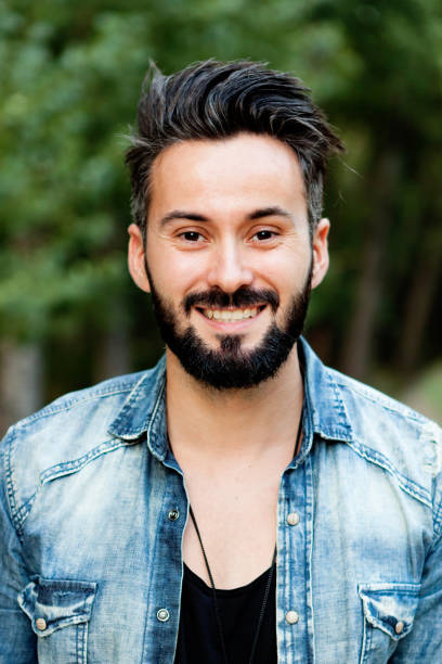 istock Young handsome bearded hipster man in the park 1188866100