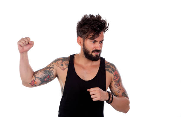 Attractive guy threatening with his fist raised isolated on a white background