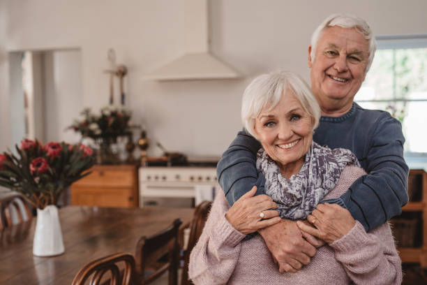 istock Affectionate senior couple standing together in their kitchen 1188867406