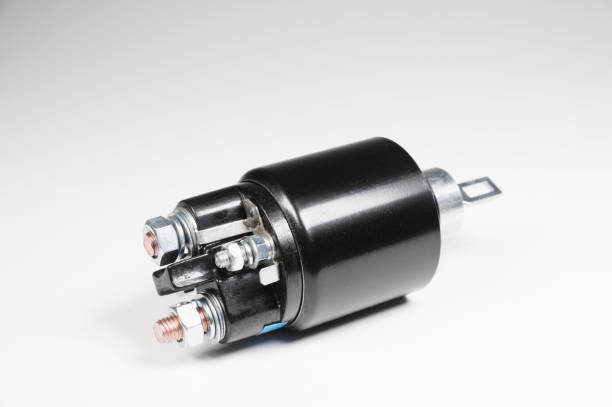 istock New black solenoid for a starter for a car on a gray gradient background. Auto parts. 1188868412