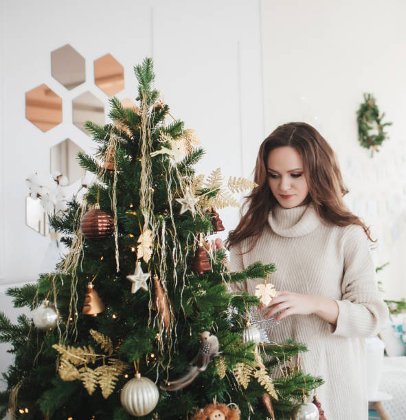 istock woman near the christmas tree 1188868454