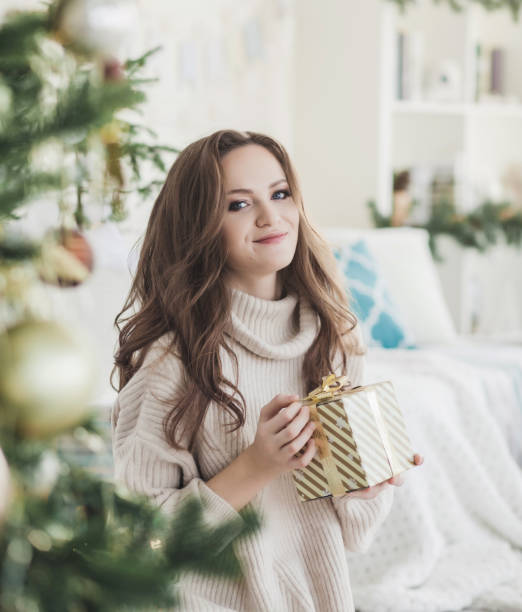 istock woman with christmas present box 1188868498