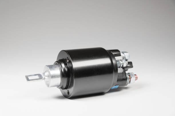 istock New black solenoid for a starter for a car on a gray gradient background. Auto parts. Starter Parts 1188868510