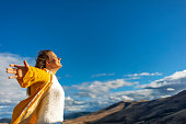 Woman taking a breath in front of a spectacular view