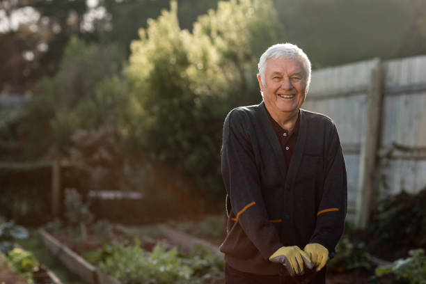 istock Smiling senior man standing in his vegetable garden 1188870053