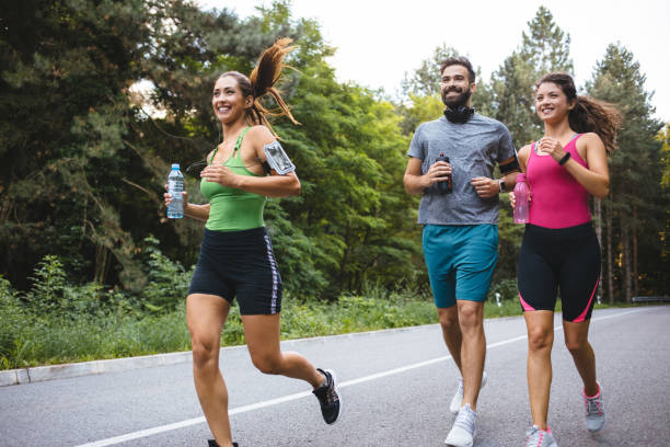 istock Friends jogging together in nature 1188870431