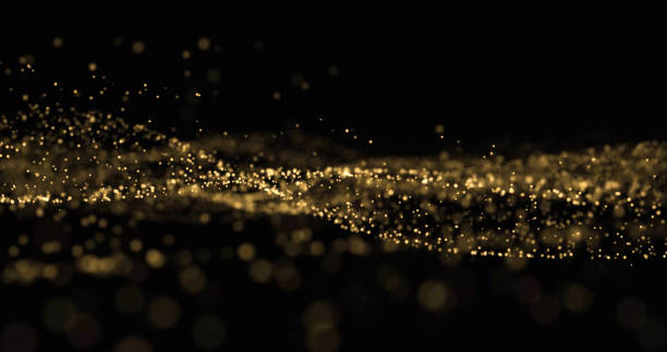 istock Golden glitter wave, light particles and dust glow splash, gold glittering light bokeh overlay on black background 1188870674