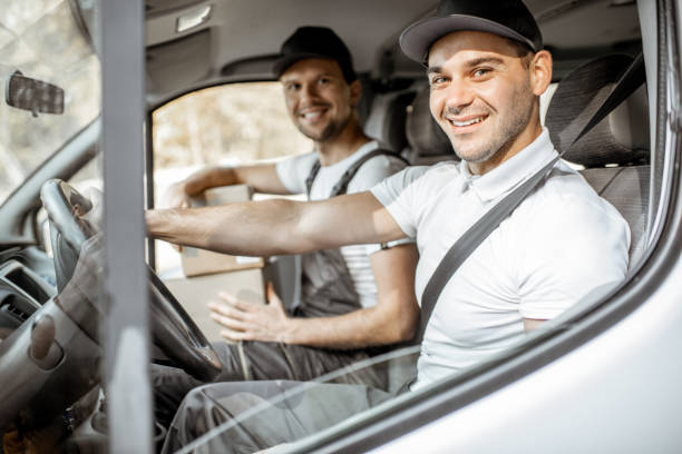 istock Delivery company employees driving a cargo vehicle 1188871445
