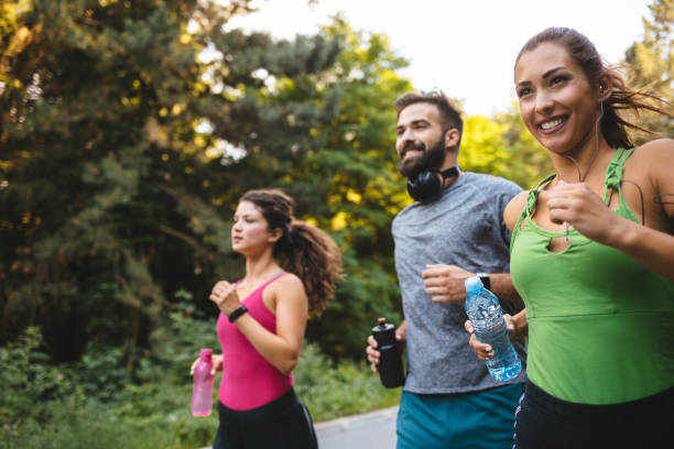 Friends jogging together in nature stock photo