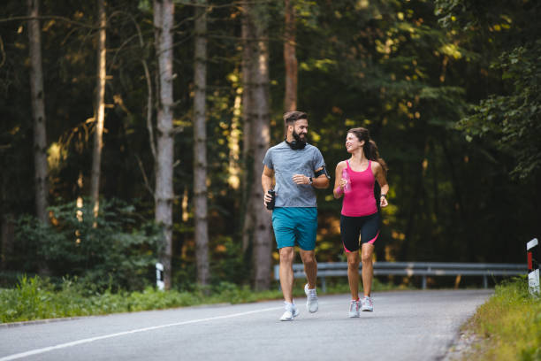 istock Young couple jogging in nature 1188871931