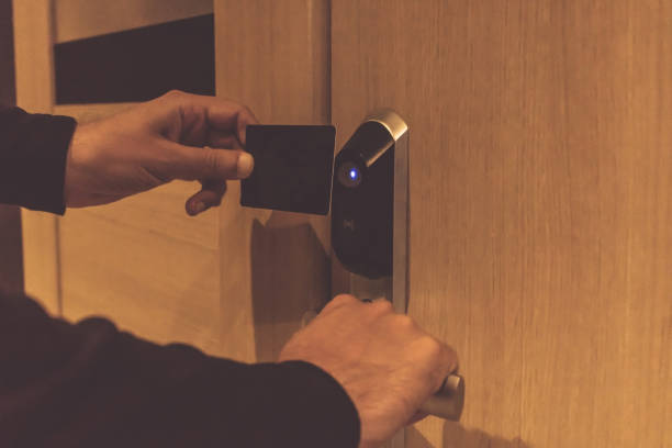 istock Close-up of man using cardkey and unlocking hotel room. 1188872180