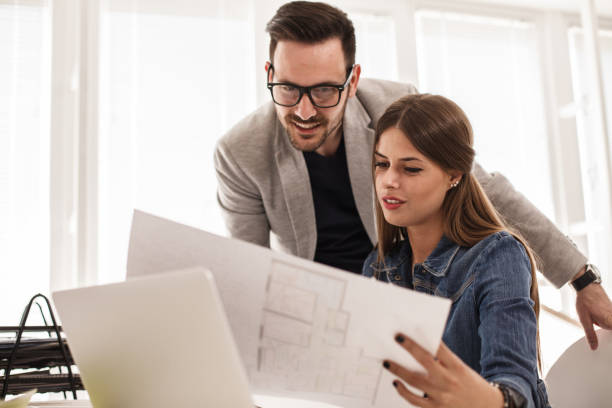 istock Coworkers reviewing important documents at work 1188873030