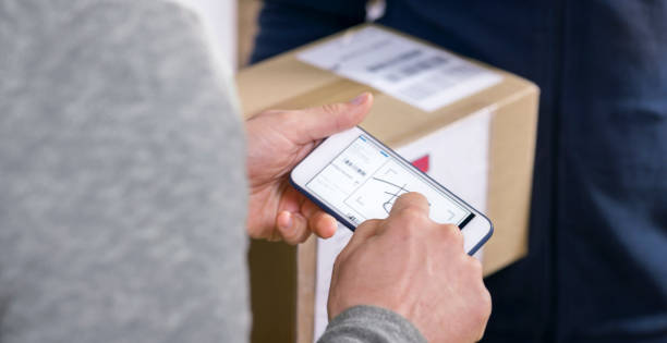 istock Man signing for package on phone 1188873056