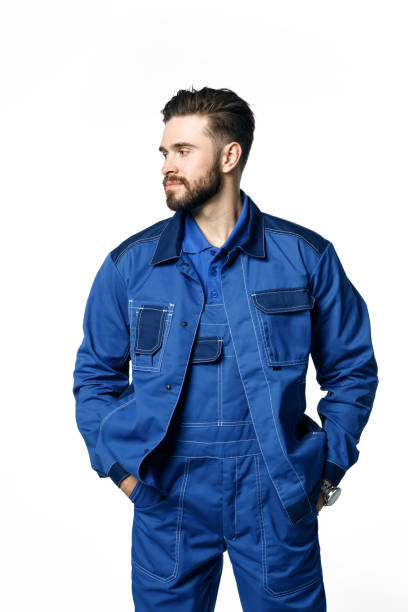 istock Young handsome man with a beard in a blue working uniform for cleaning rooms 1188873207