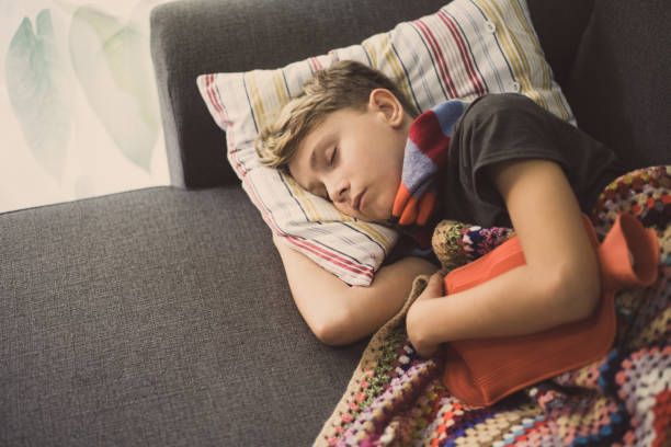 istock High Angle View Of Boy Sleeping With Hot Water Bottle On Sofa At Home 1188874812