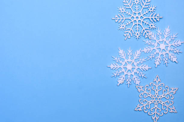 istock christmas decor background - snowflakes on blue background 1188874901