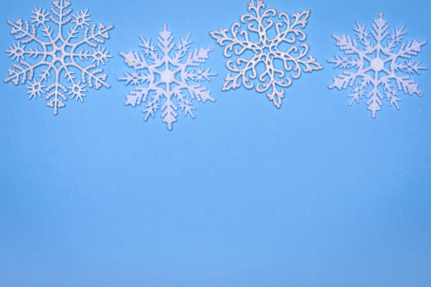 istock christmas decor background - snowflakes on blue background 1188874916