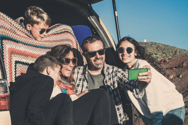 istock Family Taking Selfie By Vehicle 1188875018