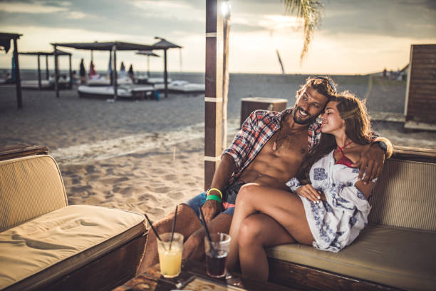 istock Happy affectionate couple relaxing in a bar at the beach. 1188876462